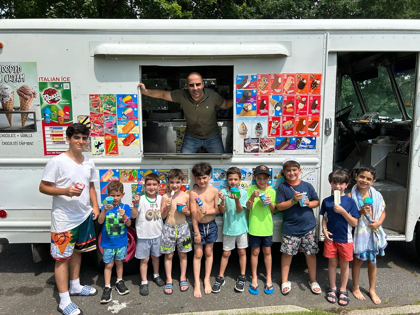 Kids lined up at the Twins Ice Cream truck with treats